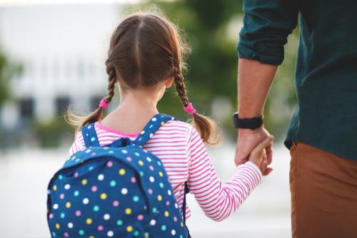 μικρό κορίτσι με σχολική τσάντα κατάλληλη για την αποφυγή σκολίωσης