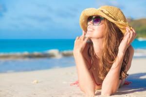 Γυναίκα κάνει ηλιοθεραπεία καλοκαίρι σε παραλία